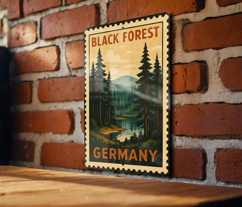 A vintage-style metal stamp depicting a forest scene with pine trees and a river, mounted on a brick wall.