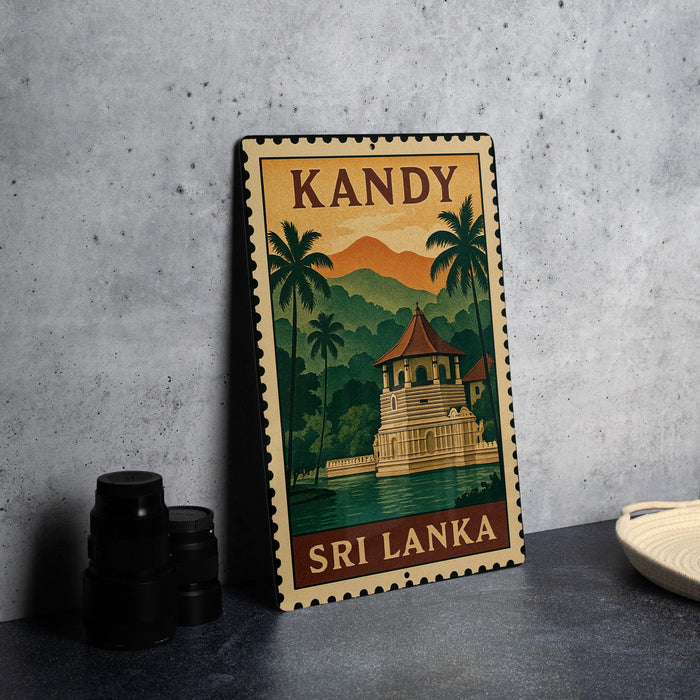 A vintage-style metal sign with a tropical island and temple illustration, featuring the word "KANDY" at the top.