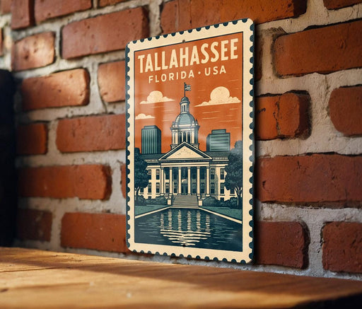 A framed illustration of the Tallahassee, Florida, USA, with a brick wall and a fountain in the background.