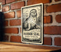 A sign featuring a seal is mounted on a brick wall.