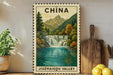 A framed vintage postage stamp depicting a waterfall in the Jizhai gorge valley in China, surrounded by lush greenery and mountains.