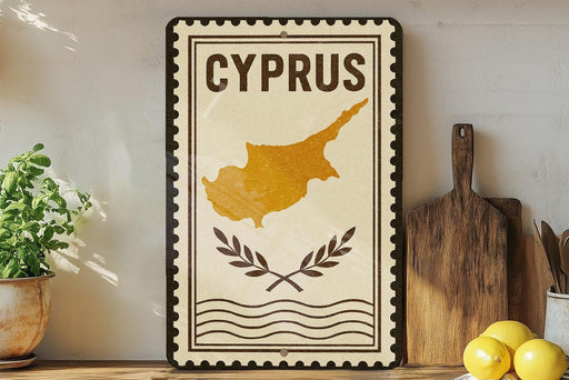 a decorative sign with the word "CYPRUS" on it, along with a map of the island of Cyprus. The sign is placed on a shelf next to a wooden cutting board and some potted plants.
