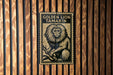 A poster of a golden lion tamarin is displayed on a wooden wall.