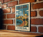A vintage-style metal sign with a cityscape and palm trees, mounted on a brick wall.