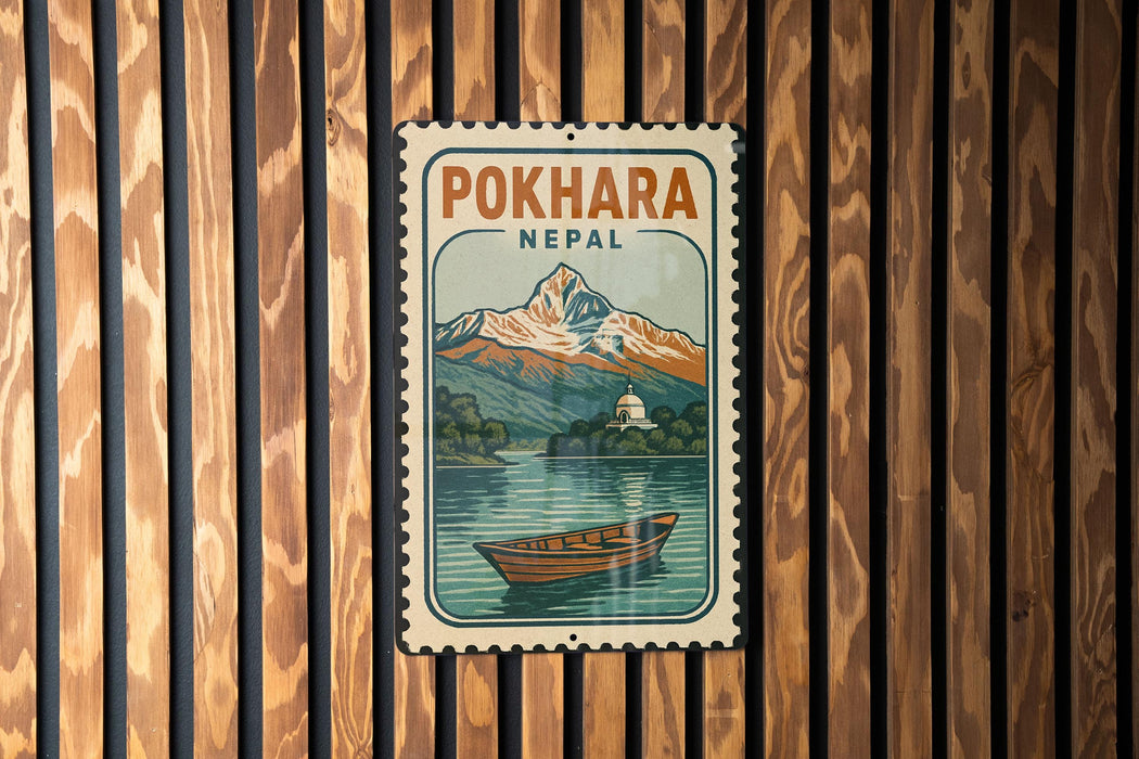 A vintage-style metal sign with the text "POKHARA NEAL" and an illustration of a mountain landscape with a boat on a lake.