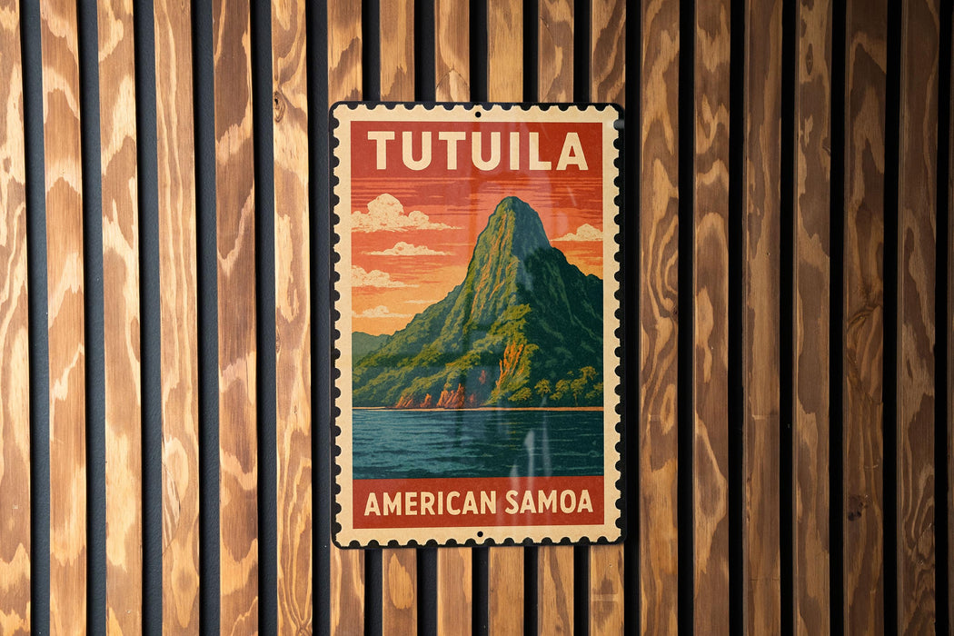 A vintage-style metal sign with the text "TUTUILA AMERICAN SAMOA" displayed on a wooden wall.