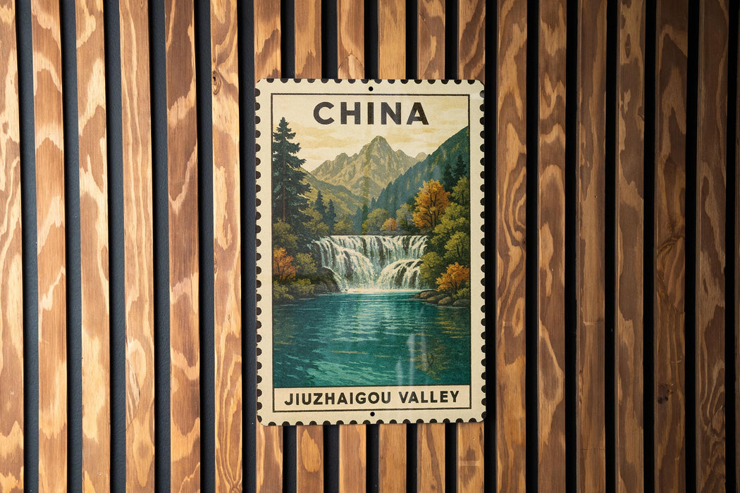 A postage stamp depicting a scenic waterfall in the JIUZHAI GOU VALLEY, China, hanging on a wooden wall.