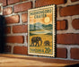 A vintage postage stamp from Tanzania depicting two elephants in a grassy field, with mountains in the background.