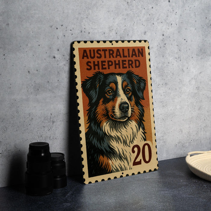 A framed illustration of an Australian Shepherd dog on a wooden postcard, with the text "AUSTRALIAN SHEPHERD" and the number "20" printed on it.