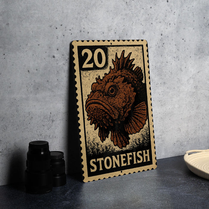 A metal sign featuring a stonefish illustration and the number 20, placed on a table next to some black camera lenses.