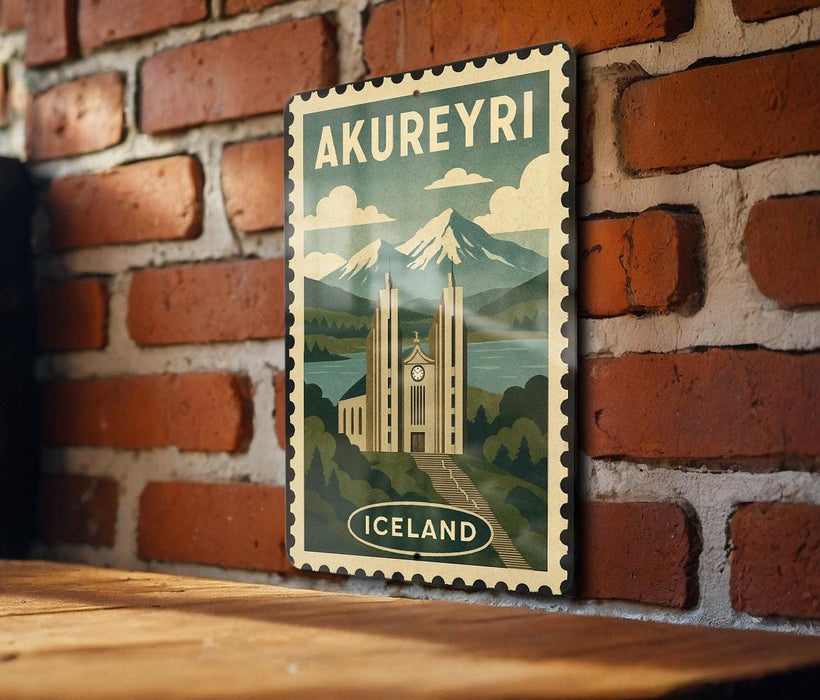 A vintage-style poster of Akureyri, the capital city of Iceland, is displayed on a brick wall.