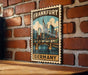 A vintage-style postage stamp depicting the city of Frankfurt, Germany, with a bridge and skyline in the background.