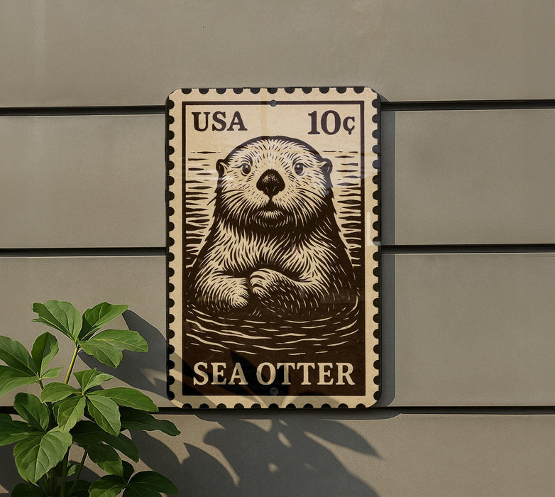 A metal sign featuring a sea otter, with a US 10¢ postage stamp on the back.