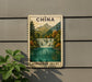 A framed postcard depicting a scenic waterfall in the Jiuzhaigou Valley, with mountains in the background.