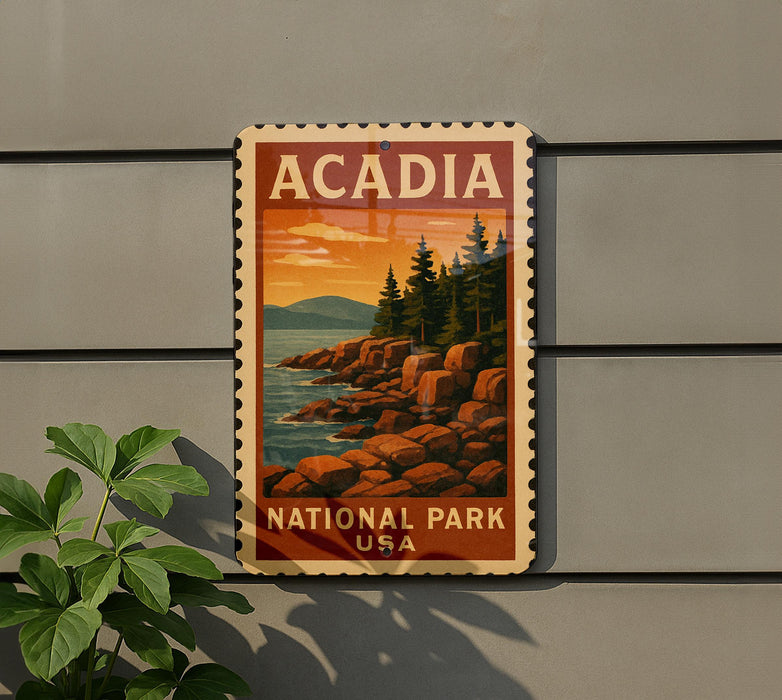 A vintage-style sign for Acadia National Park in the United States, featuring a scenic landscape with pine trees, rocky cliffs, and a sunset over the water.