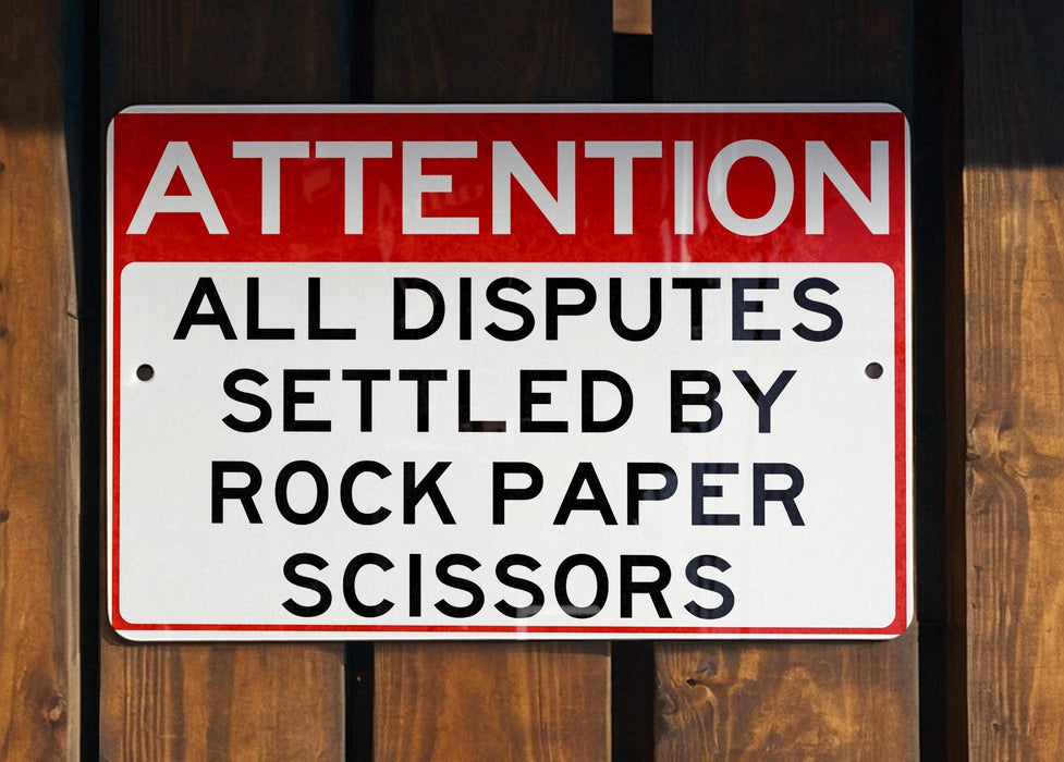 a red and white sign on a wooden fence