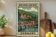 A vintage-style metal sign depicting the Heidelberg Castle in Germany, with a castle and bridge in the background.