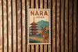 A vintage-style postage stamp depicting a pagoda and a deer, with the text "NARA JAPAN" prominently displayed.