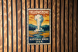 A vintage-style postage stamp featuring an illustration of a steam explosion in Yellowstone National Park, USA.