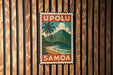 A vintage-style metal sign with the text "UPOLU SAMOA" displayed prominently, featuring a tropical beach scene with palm trees and a mountain in the background.