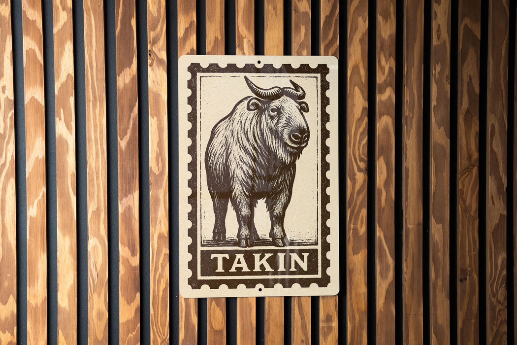 a wooden wall with a metal sign featuring a drawing of a bison or ox with the word "Takin" written below it.