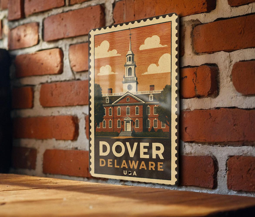 A vintage-style postage stamp featuring the historic Dover, Delaware State University, mounted on a brick wall.