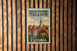 A vintage-style postage stamp from Tallinn, Estonia, featuring a cityscape with a church spire and other buildings.