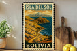 A vintage-style metal sign with the text "ISLA DEL SOL BOLIVIA" and a scenic landscape depicting a mountainous coastline and a blue ocean.