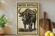 a wooden sign with a black and white illustration of a buffalo, accompanied by the text "WATER B Buffalo" on a wooden shelf.