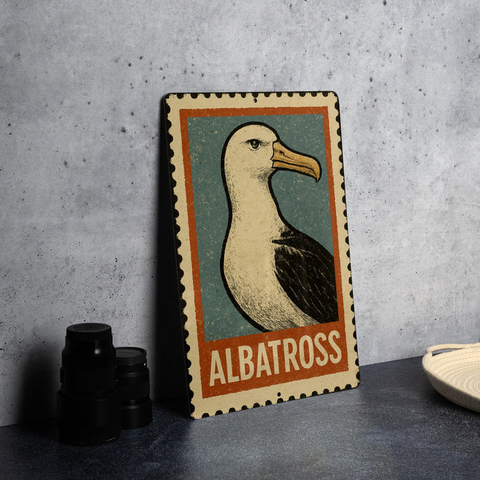 A metal sign featuring a graphic of a seagull, with the word "ALBATROSS" written below it.
