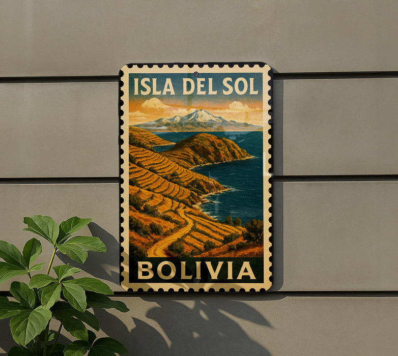 A vintage-style postage stamp depicting a mountainous landscape with a river, hanging on a wall next to a plant.