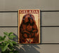 A wooden sign with a picture of a monkey and the word "GELADA" on it, mounted on a wall.