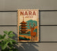 A vintage-style sign with the word "NARA" and "JAPAN" printed on it, featuring a pagoda and a deer in the background.