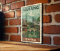 A vintage-style poster of a Chinese cityscape with mountains in the background, displayed on a brick wall.