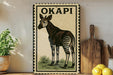 a decorative metal sign with a zebra illustration, placed on a wooden surface next to a potted plant and a wooden cutting board.