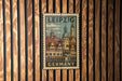 A vintage-style metal stamp depicting the Leipzig cityscape, with the text "LEIPZIG GERMANY" prominently displayed.