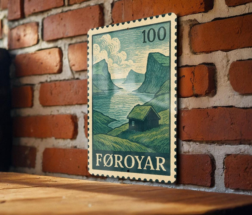 A wooden table with a framed image of a rural landscape, depicting a small house and mountains, mounted on a brick wall.