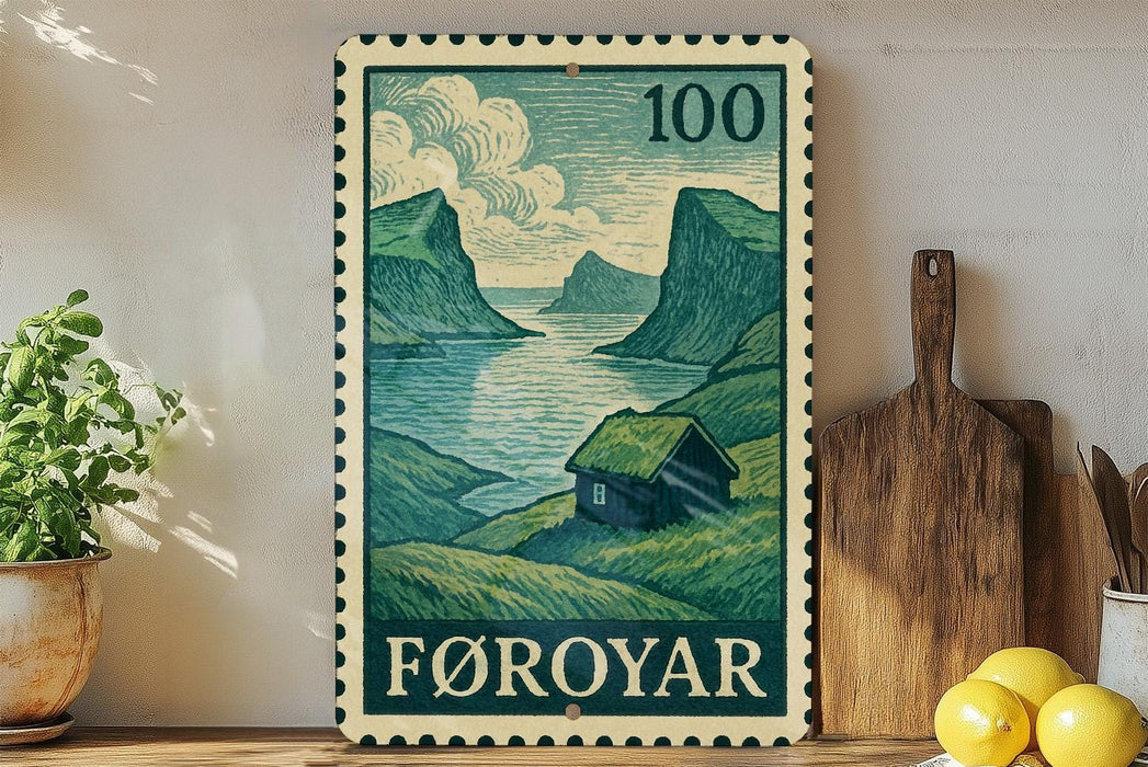 a framed illustration of a coastal landscape with mountains, a small house, and a river, along with a postage stamp in the foreground.