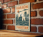 A vintage-style sign with the text "KARACHI PAKISTAN" displayed on a brick wall.