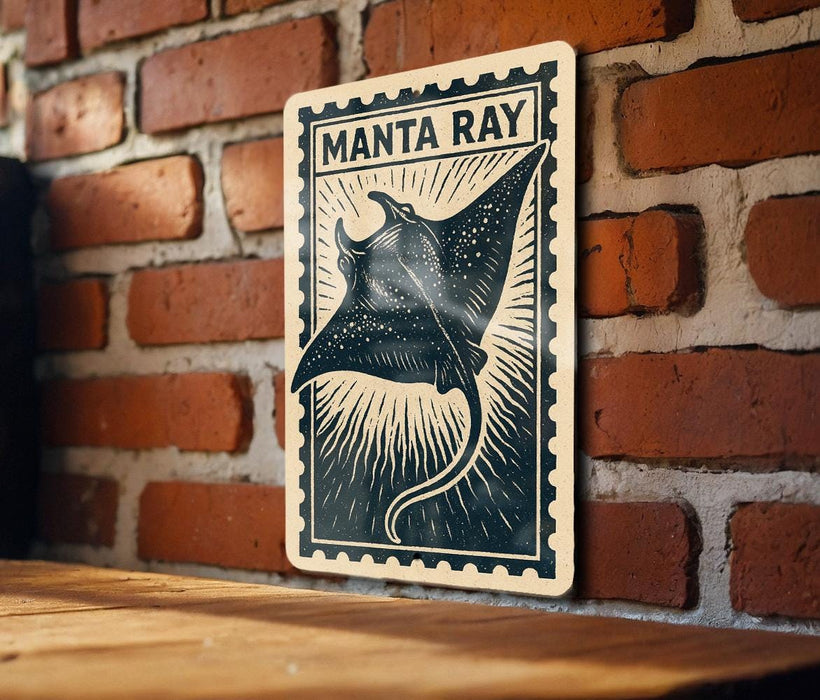 A framed image of a manta ray, a type of ray, is displayed on a brick wall.