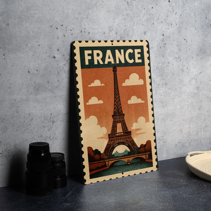 A vintage-style metal sign featuring the Eiffel Tower, a famous landmark in France, is displayed on a table.