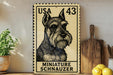 A miniature schnauzer dog stamp is displayed on a shelf, surrounded by kitchen utensils and a potted plant.
