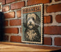 A framed illustration of a Havanaese dog is displayed on a brick wall.