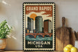 A vintage-style metal sign with a cityscape and a bridge, depicting the Grand Rapids, Michigan, USA.