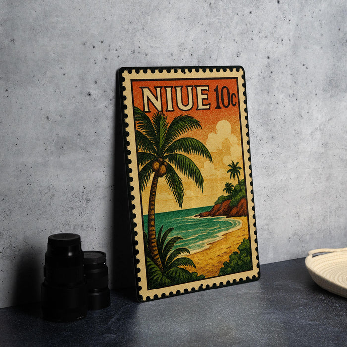 A vintage postage stamp depicting a tropical beach scene with palm trees and a sunset over the ocean.