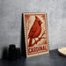 A metal sign featuring a red cardinal perched on a branch, with the word "CARDINAL" written below the bird.