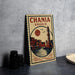 A vintage-style poster of Chania, Greece, featuring a lighthouse and a cityscape, is displayed on a gray wall.