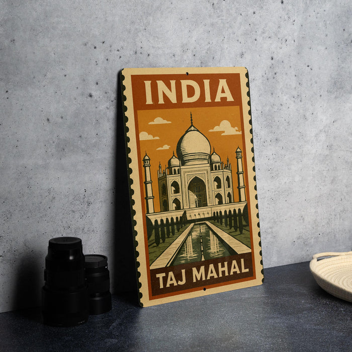 A vintage-style metal sign featuring the Taj Mahal, a famous landmark in India, is displayed on a table.