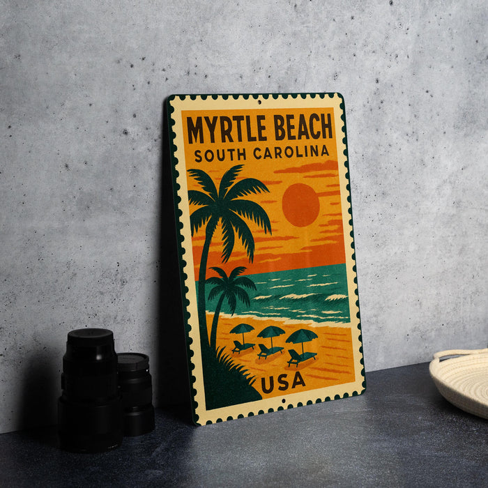 A vintage-style metal sign with a beach scene and palm trees, featuring the text "MYRTLE BEACH SOUTH CAROLINA USA" and an orange and yellow sunset.