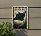 a decorative sign with a manta ray illustration, mounted on a wall next to a plant.